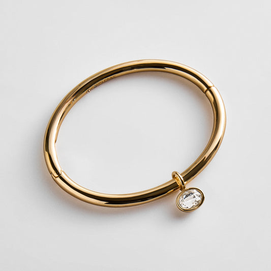 Lavisa gold hinge bangle bracelet featuring a sparkling crystal drop charm
