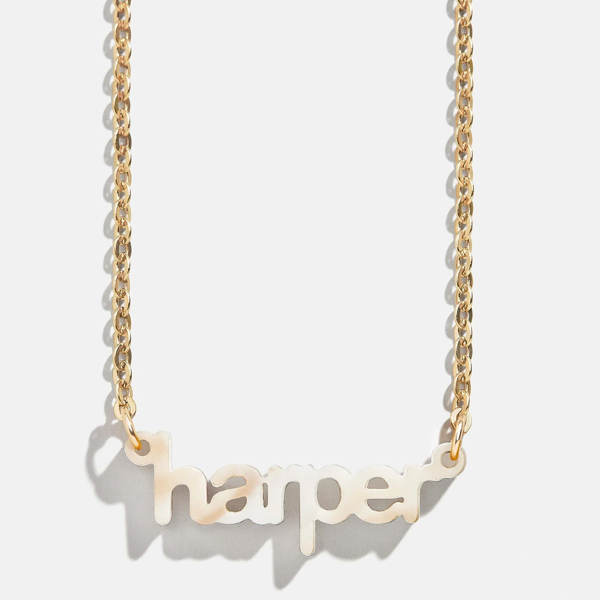 Lavisa Custom Acrylic Nameplate Necklace displayed in gold with custom lettering