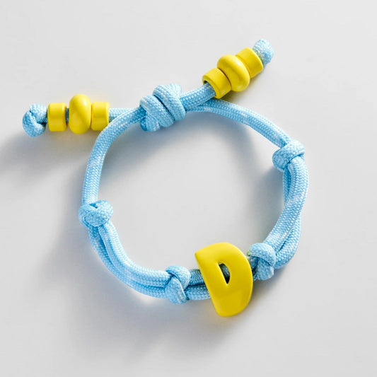 Lavisa custom initial enamel bracelet featuring colorful bubble letters on a waterproof cord