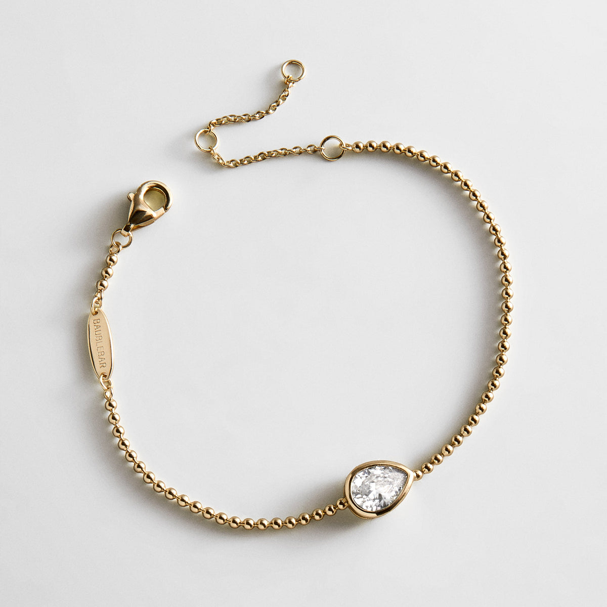 Lavisa Gold Crystal Pear Cut Bracelet featuring a brilliant bezel-set stone on a dainty gold chain.