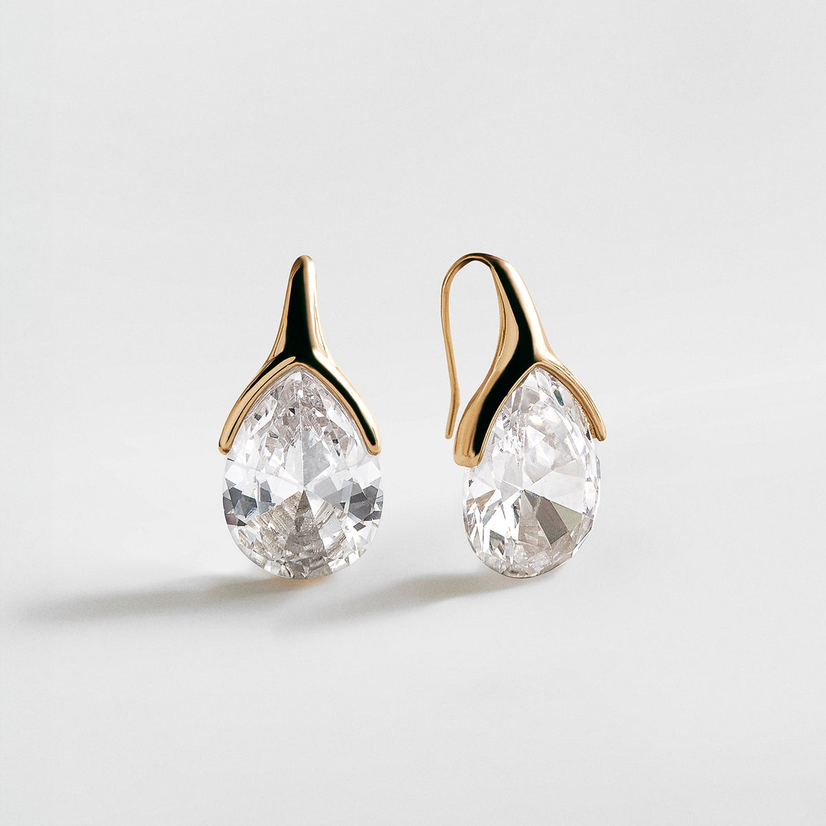 Lavisa bold gold crystal drop earrings on a minimalist background