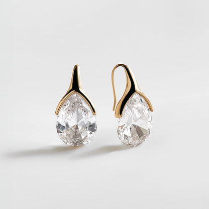 Lavisa bold gold crystal drop earrings on a minimalist background