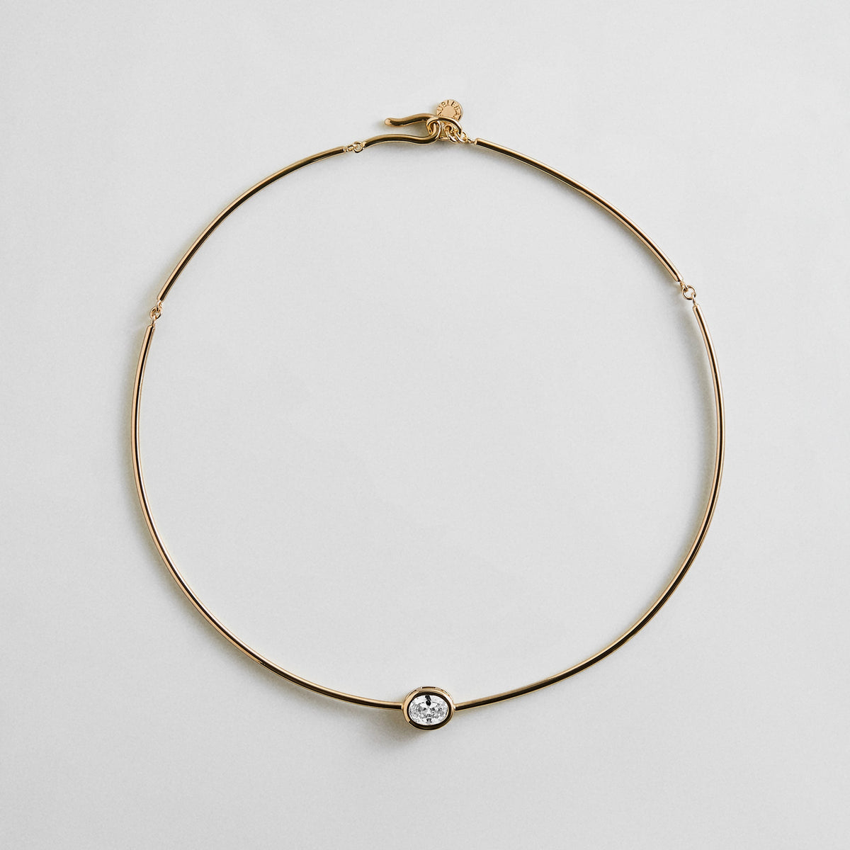 Lavisa gold wire collar necklace with an oval crystal bezel centerpiece