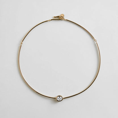 Lavisa gold wire collar necklace with an oval crystal bezel centerpiece