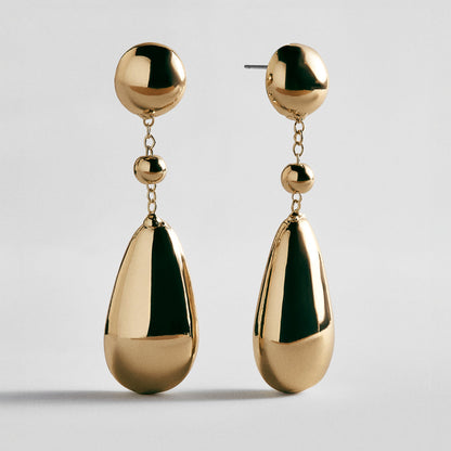 Lavisa gold statement earrings featuring a round base and bold pear-shaped design.