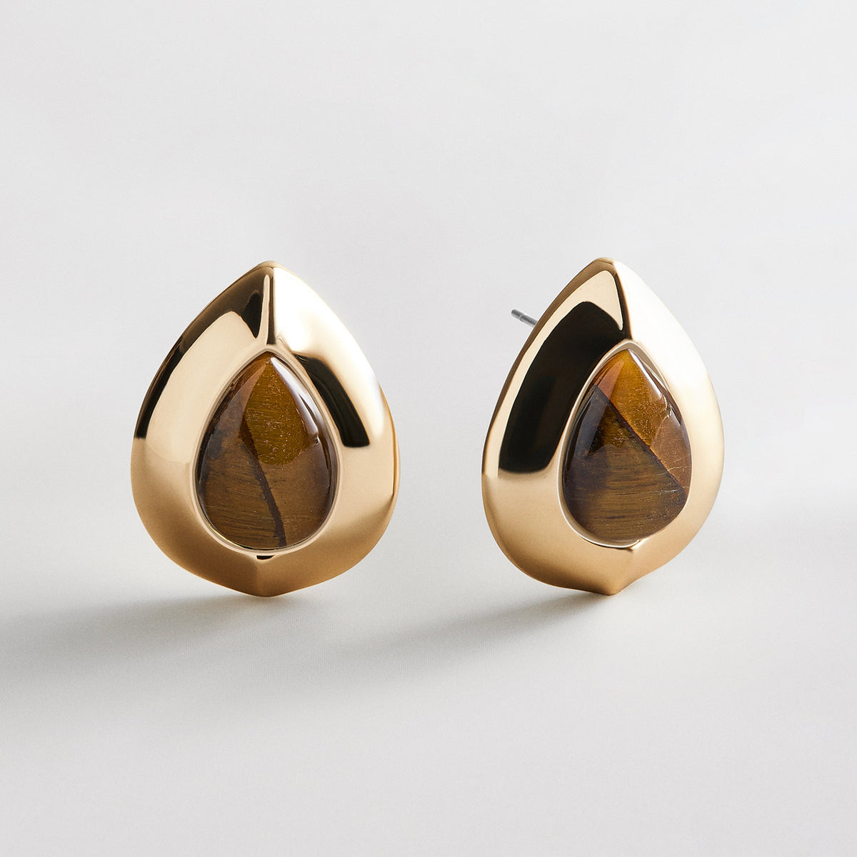 Lavisa semi-precious statement stud earrings featuring a gold finish and tiger eye center stone