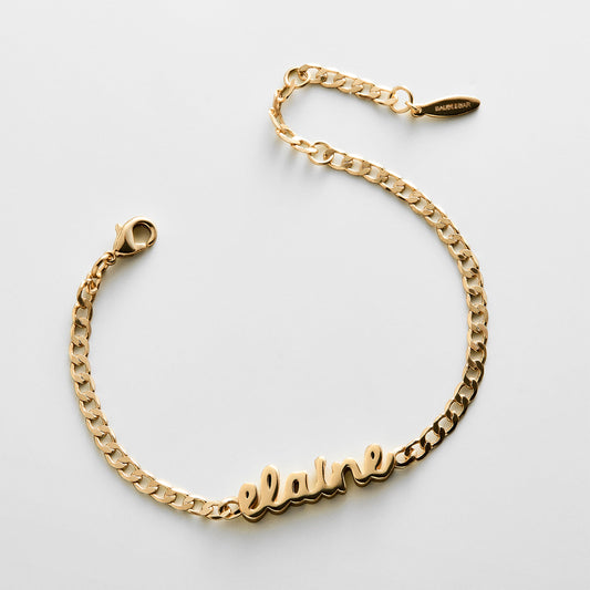 Lavisa custom gold curb chain name bracelet resting on a clean surface