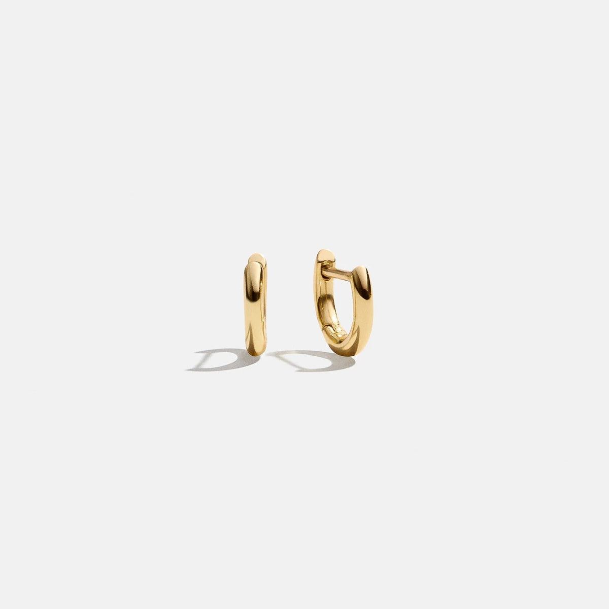 Lavisa classic 10mm gold huggie hoop earrings displayed cleanly on a white backdrop