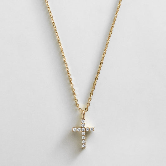 Lavisa 14K Gold Cross Necklace featuring sparkling cubic zirconia stones on a delicate gold chain.