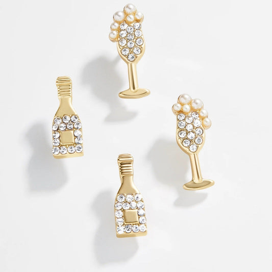 Lavisa champagne flute and bottle novelty earring set resting on a neutral background