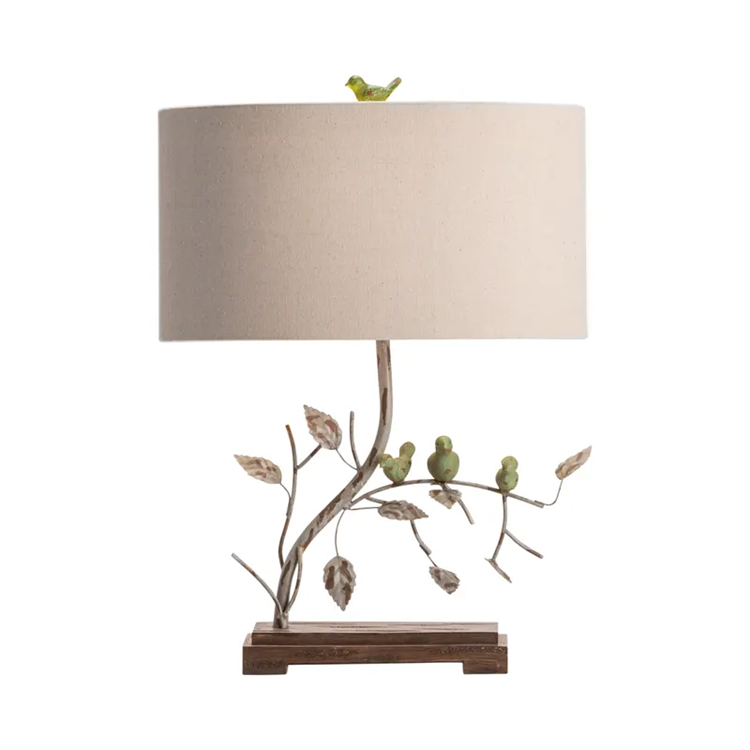 Lavisa nature-inspired table lamp with sculpted birds on a branch and a linen shade