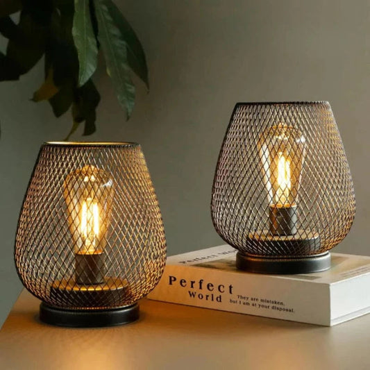 Lavisa Dimmable LED Metal Lantern Set glowing warmly on an outdoor wooden table