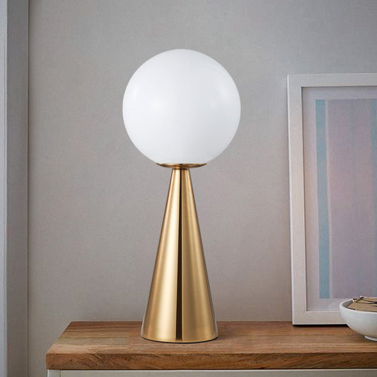 Lavisa Modern Brass Table Lamp with Frosted Glass Globe on a bedside table
