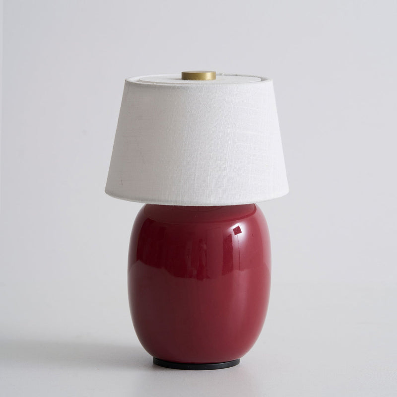 Lavisa Petite Battery Operated Table Lamp glowing on a wooden tabletop - D 4.7″ x H 7.9″ / D 12cm x H 20cm
