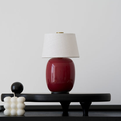Lavisa Petite Battery Operated Table Lamp glowing on a wooden tabletop (View 9)
