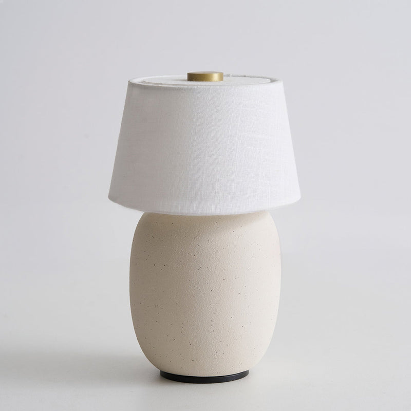 Lavisa Petite Battery Operated Table Lamp glowing on a wooden tabletop (View 4)